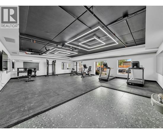 A spacious garage with a tiled floor and a high ceiling.