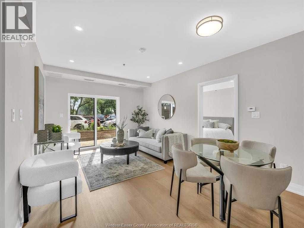 A well-lit, modern dining room with a glass table and chairs.