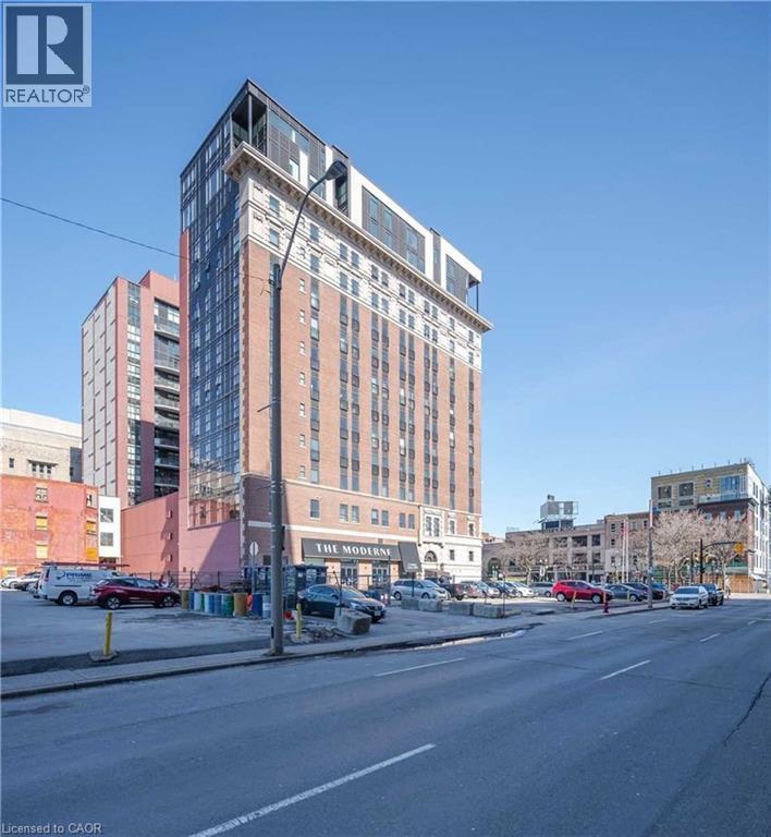 A tall building with a sign that says "The Modern" on it.