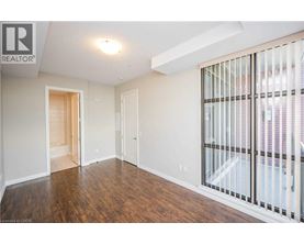 A spacious room with wooden floors and white walls.