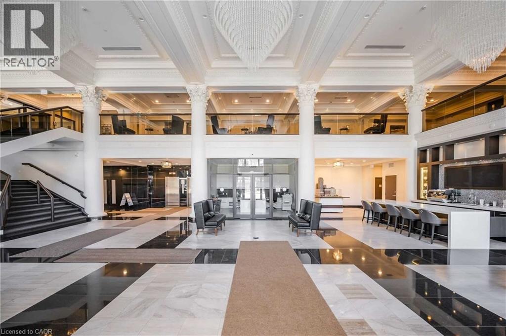 A large, open-concept living space with a marble floor and a central staircase.
