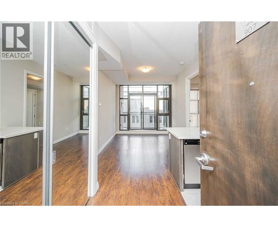 A modern kitchen with a wooden floor and white walls.