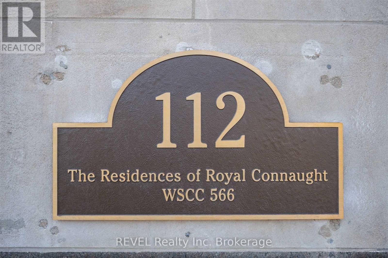 A sign that reads "112 The Residences of Royal Connaught WSCC 566" is displayed on a wall.