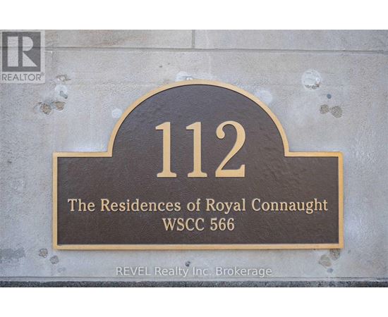 A sign that reads "112 The Residences of Royal Connaught WSCC 566" is displayed on a wall.