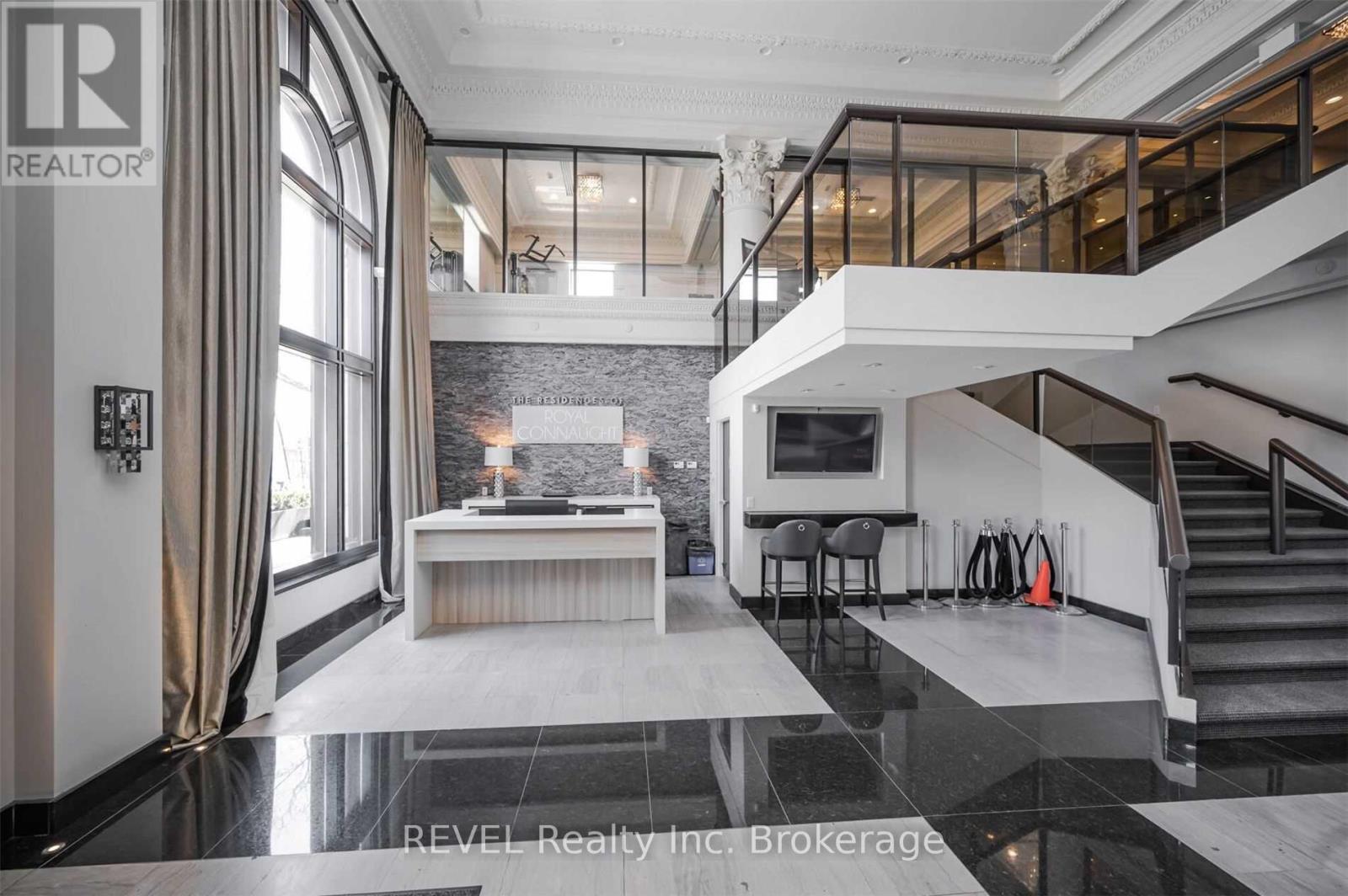 A modern living room with a staircase leading to the upper level.