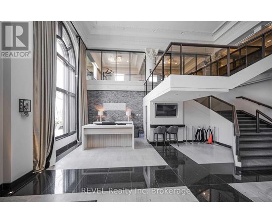 A modern living room with a staircase leading to the upper level.