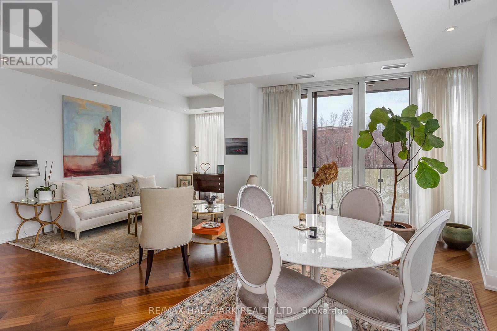 A dining room with a white table and chairs.