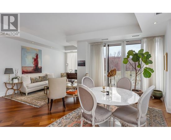 A dining room with a white table and chairs.
