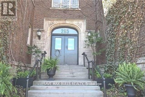 The front steps of a building with a sign that says "Save Max Bulls Realty Brokerage".