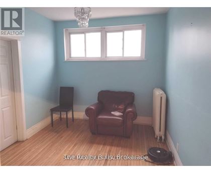 A room with a brown leather chair and a white radiator.