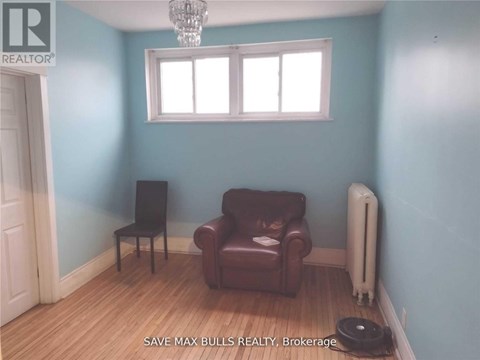 A room with a brown leather chair and a white radiator.