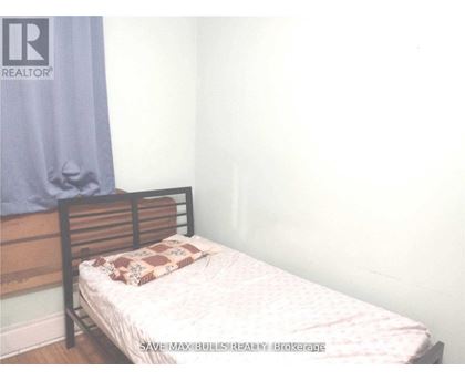 A bedroom with a bed and a pillow on it.