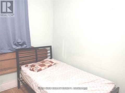 A bedroom with a bed and a pillow on it.