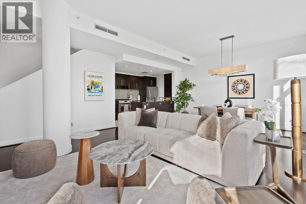 A modern living room with a white couch and a coffee table.
