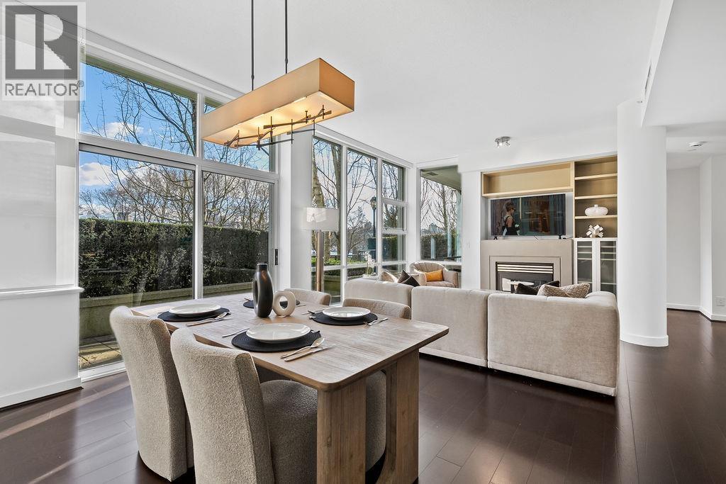A modern dining room with a wooden table and chairs.