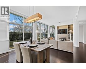 A modern dining room with a wooden table and chairs.