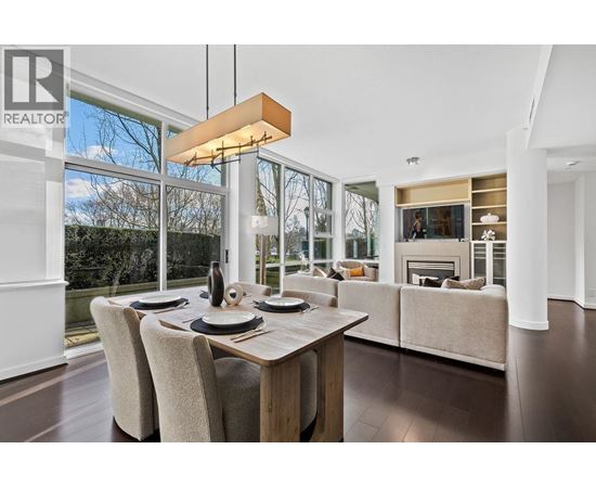 A modern dining room with a wooden table and chairs.