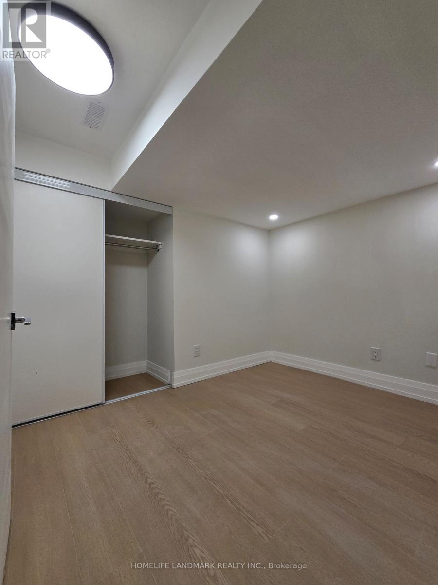 A room with a white door and a wooden floor.