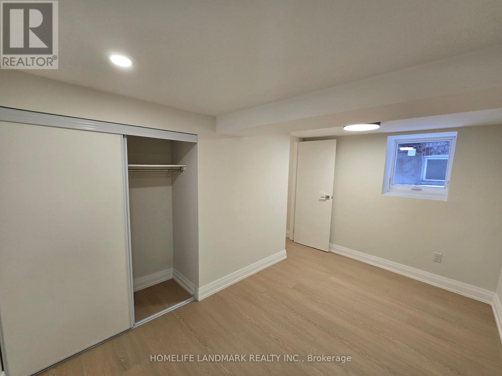 A room with a sliding door and a window.