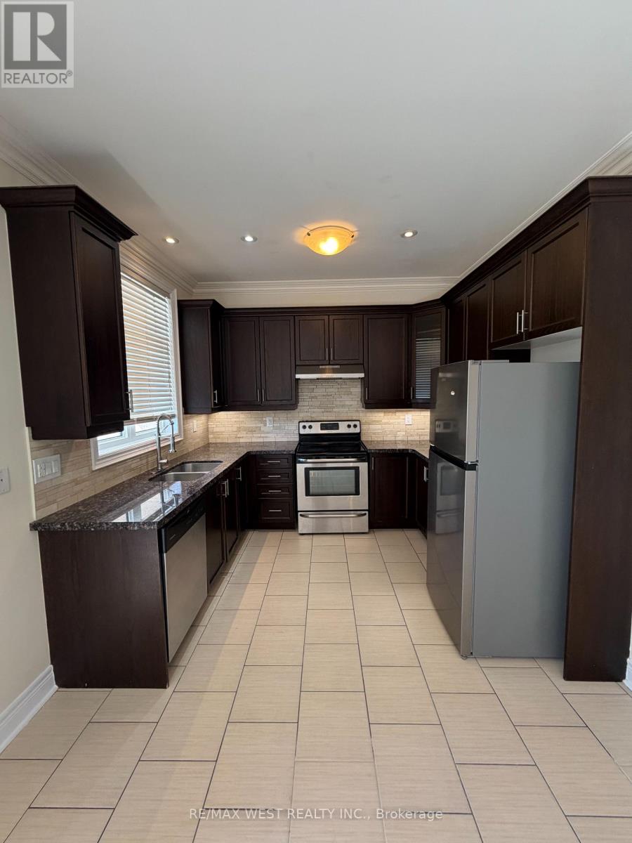 A kitchen with dark brown cabinets and a white refrigerator.