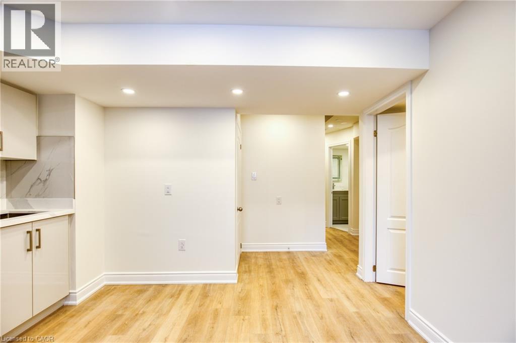 A spacious room with wooden floors and white walls.