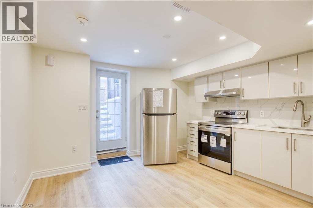 A kitchen with white cabinets and stainless steel appliances.