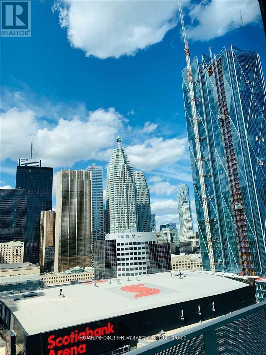 A view of a cityscape with a large building under construction in the foreground.