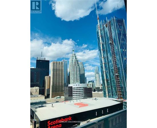 A view of a cityscape with a large building under construction in the foreground.