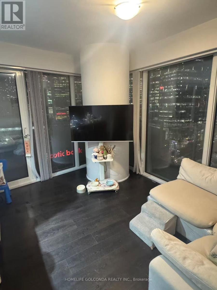 A living room with a flat screen TV and a fireplace.