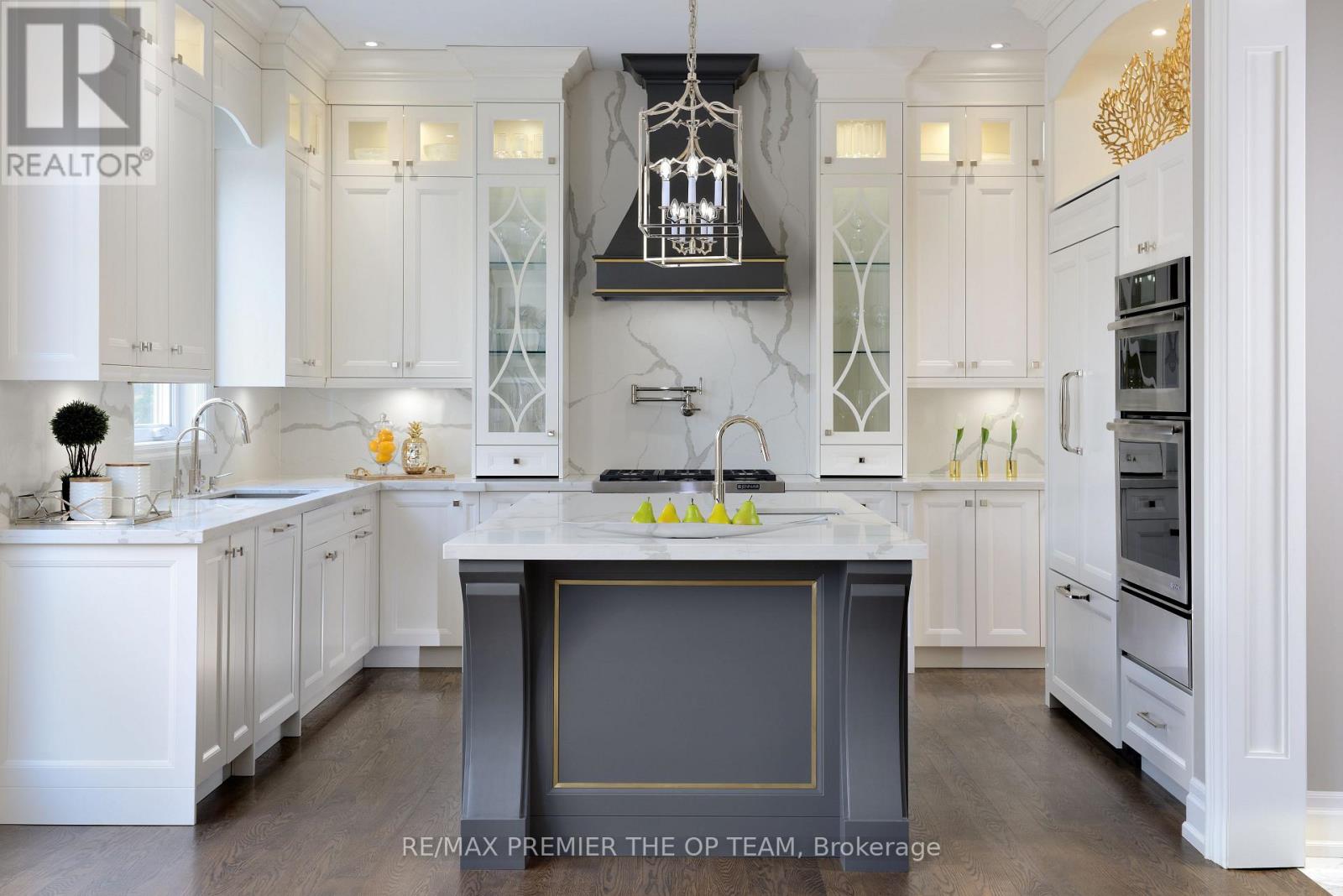 A modern kitchen with white cabinets and a central island.