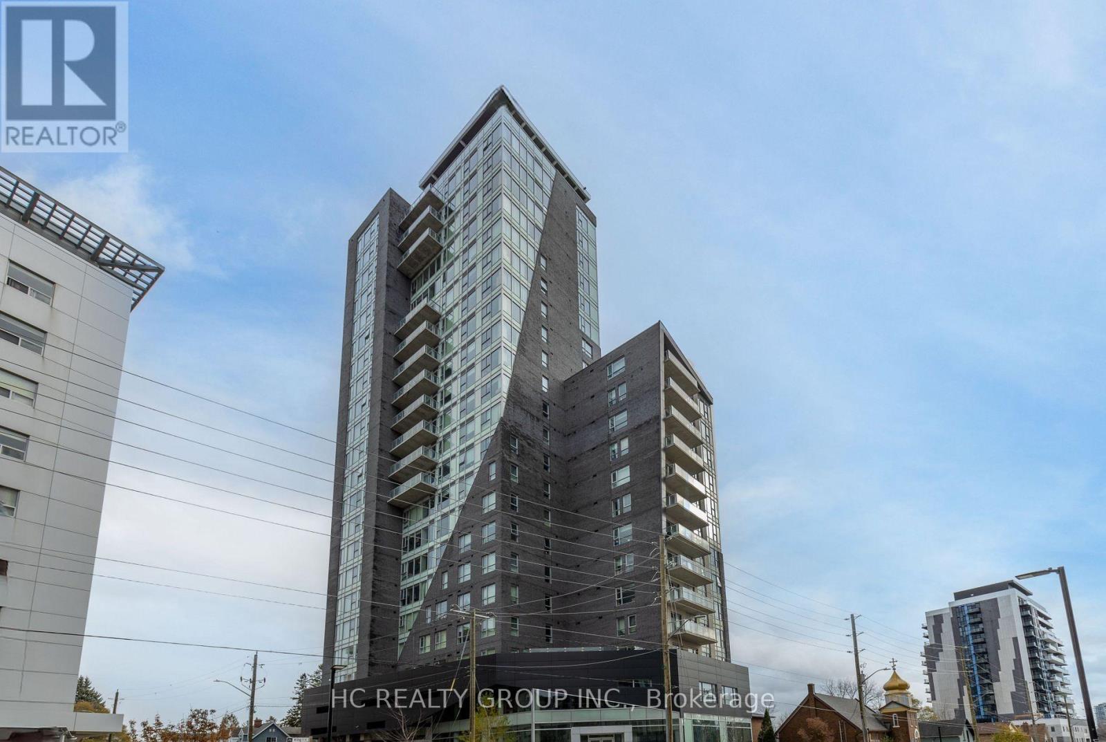 A tall building with many windows is the main focus of the image.