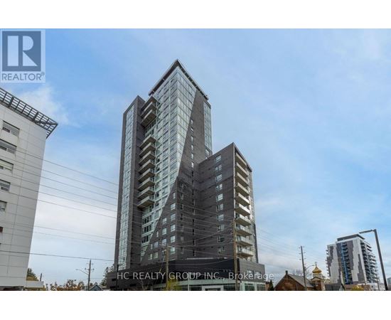 A tall building with many windows is the main focus of the image.
