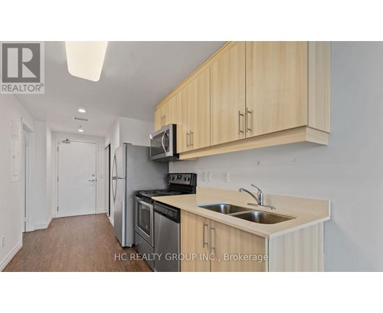 A kitchen with wooden cabinets and stainless steel appliances.