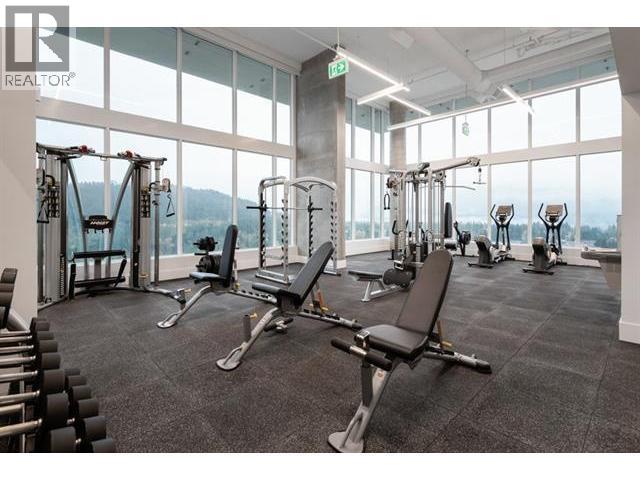 A gym with a variety of equipment including weights and machines.