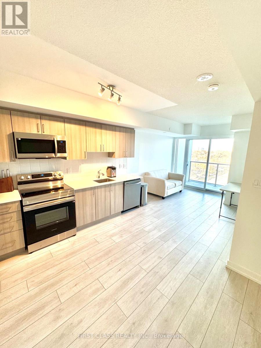 A white bedroom with a window and a carpeted floor.
