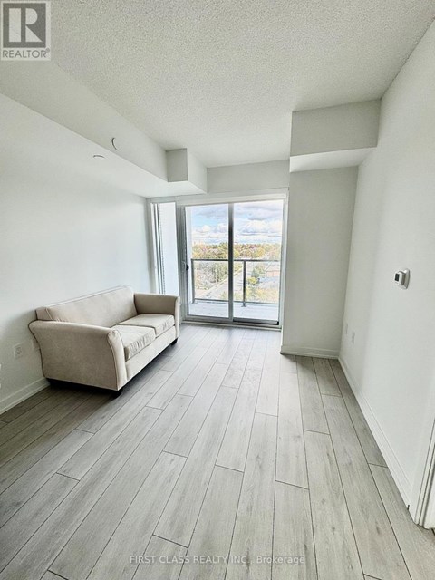 A living room with a couch and a sliding glass door.