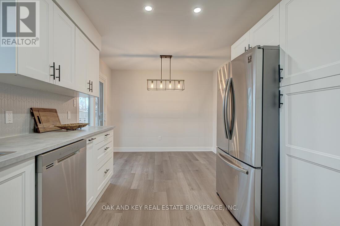 A modern kitchen with a refrigerator on the right and a dishwasher on the left.