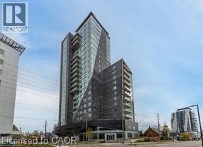 A tall building with many windows is the main focus of the image.