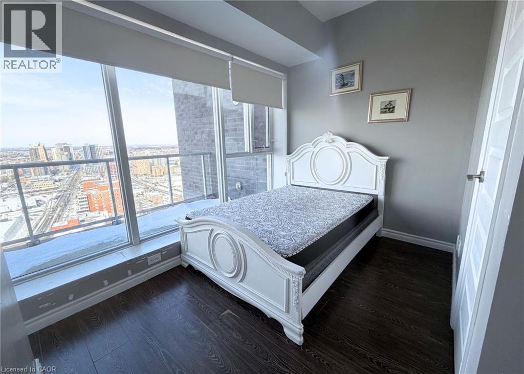 A bedroom with a large bed and a view of the city.