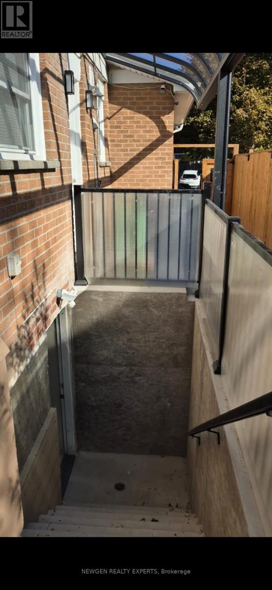 A narrow alleyway with a metal gate at the end.