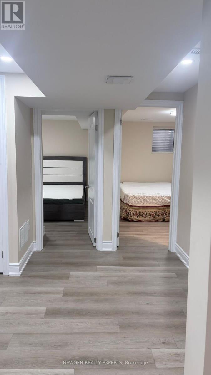 A bedroom with a bed and a wooden floor.