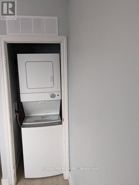 A white dishwasher is built into a wall.