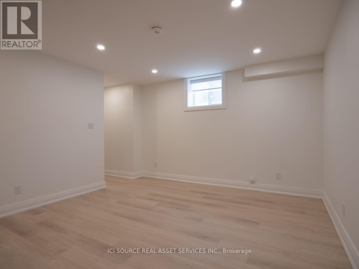A room with a window and wooden flooring.