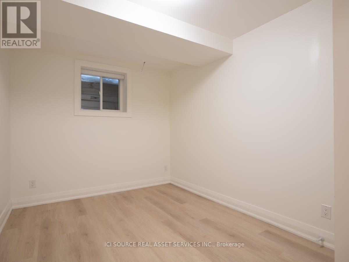 A room with a window and wooden flooring.
