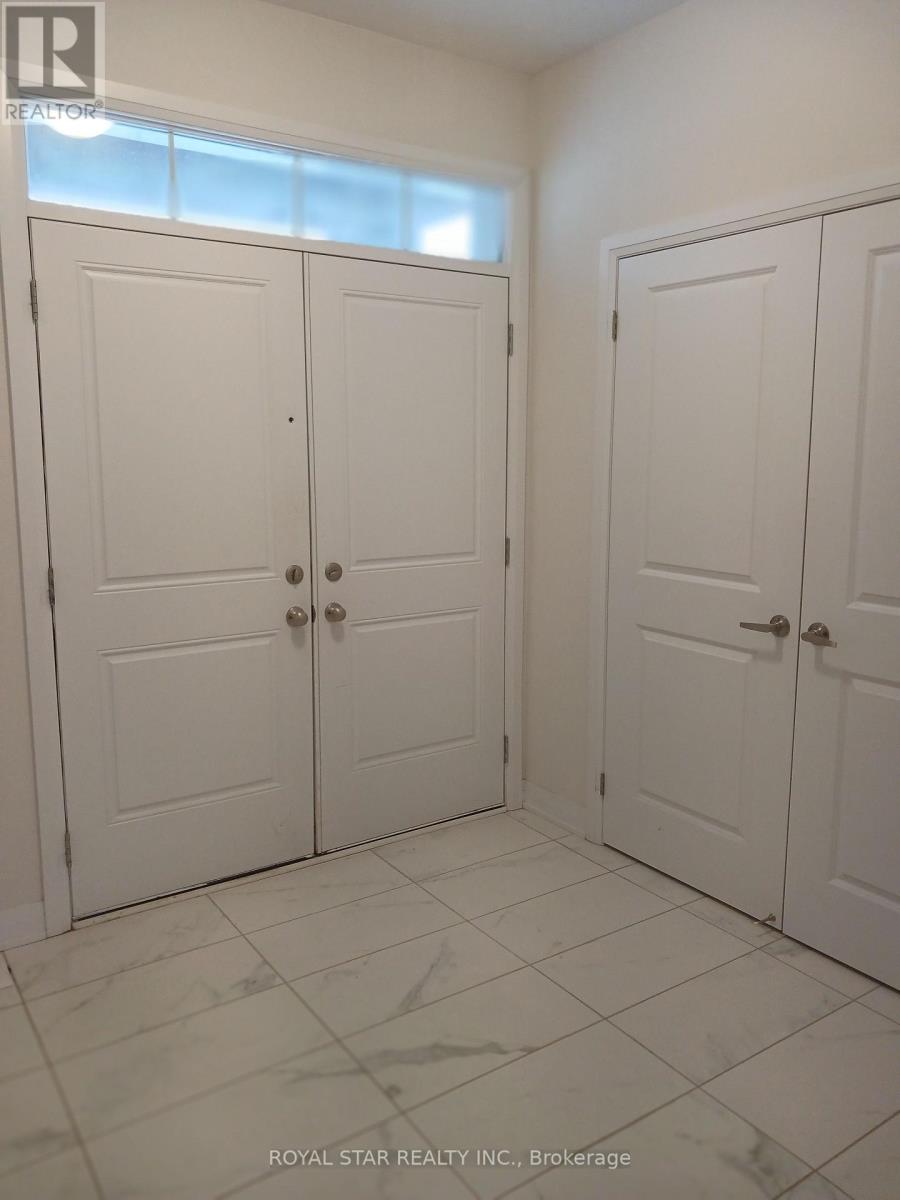 A white room with three doors and a tiled floor.