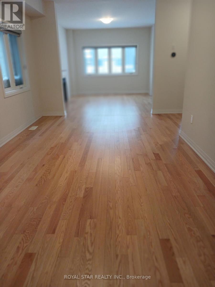 A room with wooden flooring and white walls.