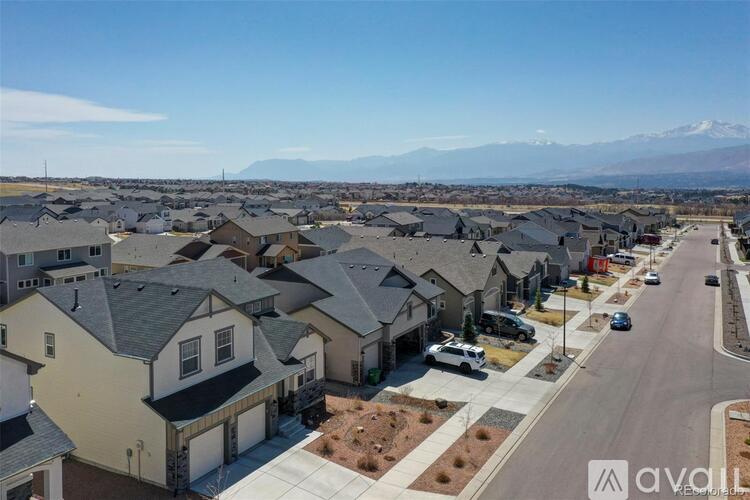 A residential area with houses and a mountain in the background.