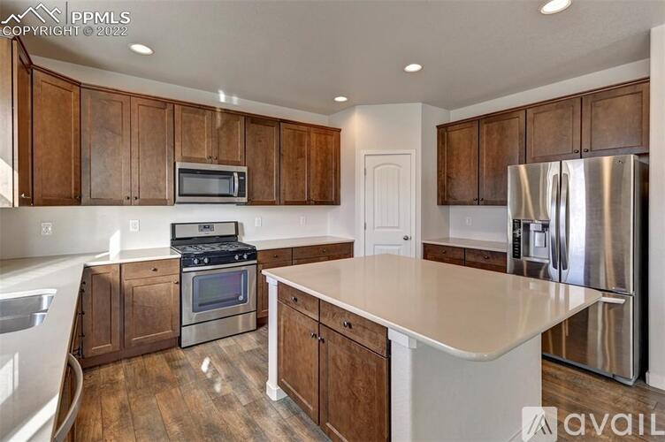 A kitchen with wooden cabinets and stainless steel appliances.