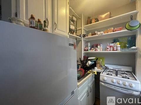 A kitchen with a white refrigerator and a white stove.