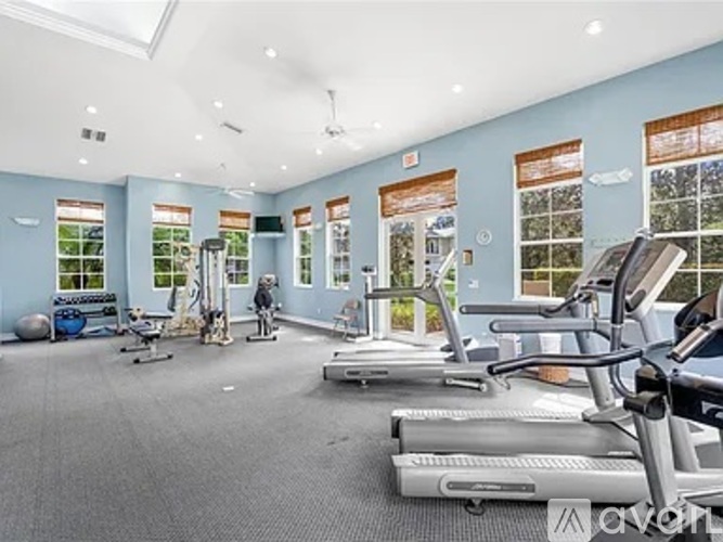 A gym with treadmills, exercise bikes, and other equipment.